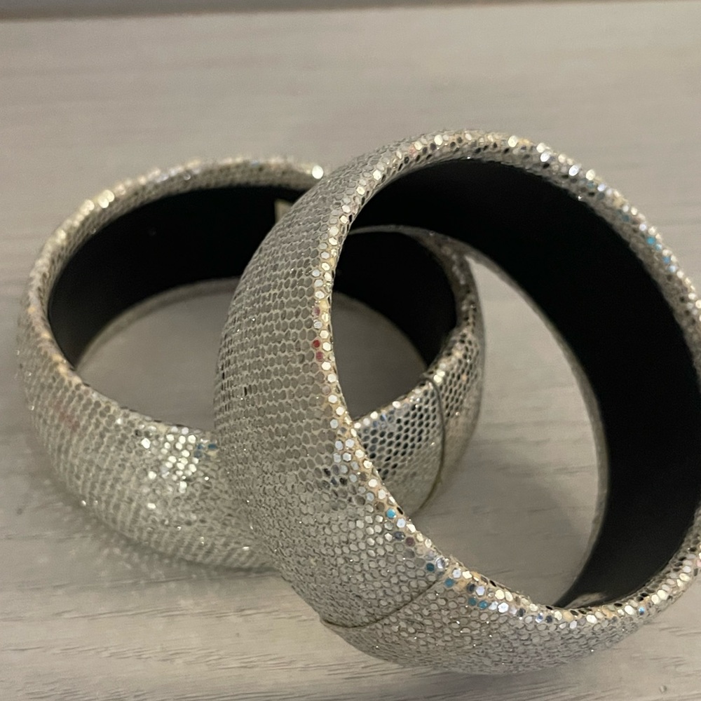 Two rigid silver sparkly cuff bracelets